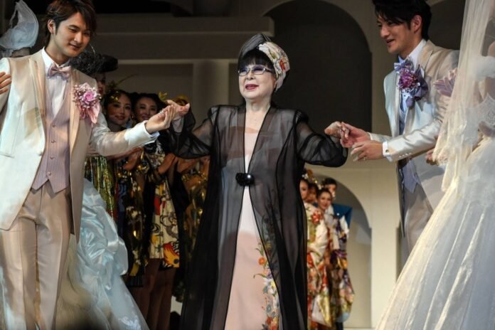 Japanese fashion designer Yumi Katsura (center) greets guests during the finale of the 2015 Yumi Katsura Grand Collection in Tokyo. Katsura has died at the age of 94. 