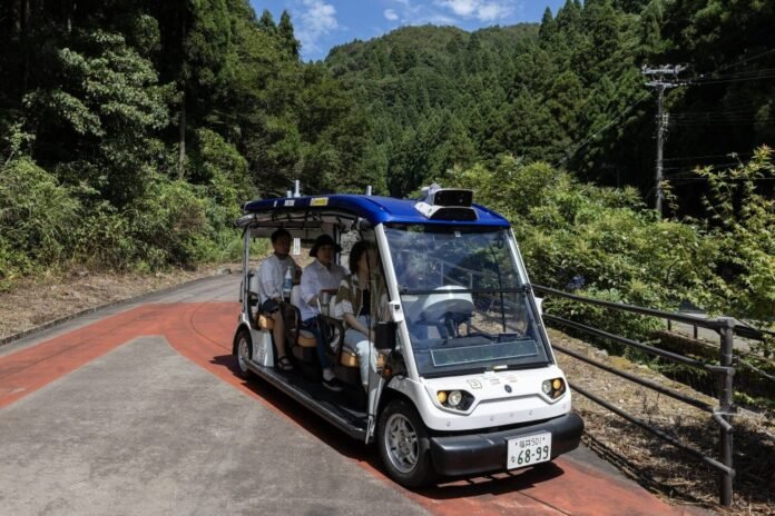 Passengers onboard a self-driving vehicle in Eiheiji, Fukui Prefecture, last year 