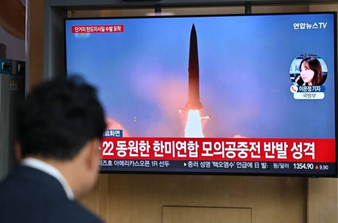 A man watches a news broadcast with file footage of a North Korean missile test, at a railway station in Seoul on May 17. 