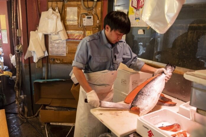A vendor cuts salmon at the Tsukiji outer market in Tokyo. Japan and Russia have agreed on this year's Japanese fishing quotas for salmon and trout. 