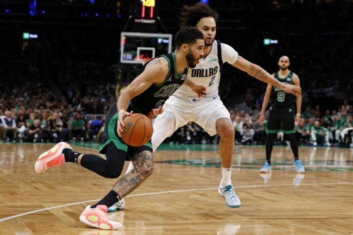 The Celtics' Jayson Tatum drives against Mavericks center Dereck Lively during the third quarter in Game 2 of the NBA Finals in Boston on Sunday. 