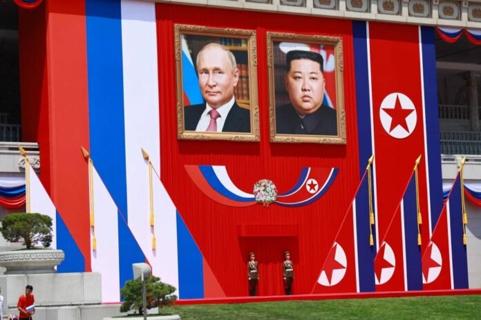Portraits of North Korean leader Kim Jong Un (right) and Russian President Vladimir Putin during a welcome ceremony at Kim Il Sung Square in Pyongyang on Wednesday. 