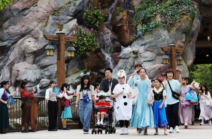 People enter the Fantasy Springs area that opened Thursday at Tokyo DisneySea in Urayasu, Chiba Prefecture. 