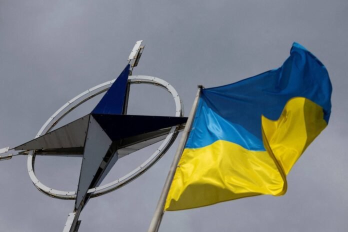 A Ukrainian national flag is pictured in front of the NATO emblem, amid Russia's attack on Ukraine, in central Kyiv, in July last year. 