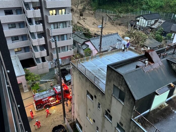 A photo provided by a local resident shows buildings in Matsuyama, Ehime Prefecture, damaged by a landslide on Friday. 