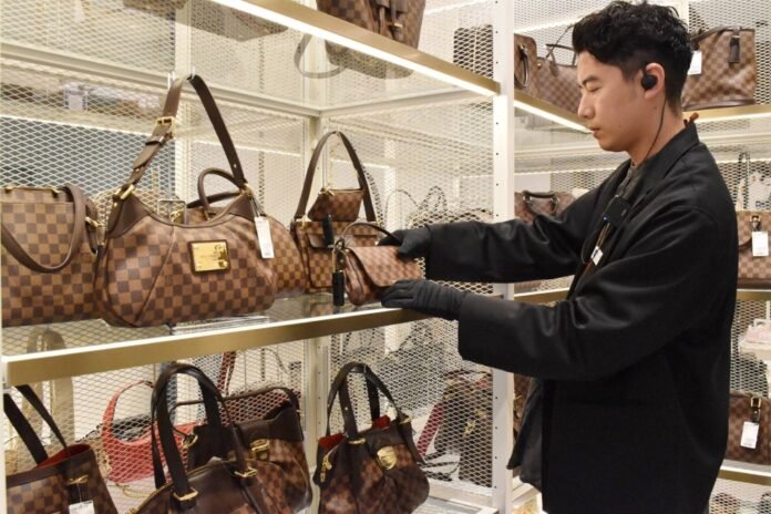 An employee checks on items at a Komehyo store in Nagoya. 