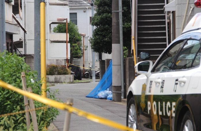 Police investigate the site where a newborn baby was found abandoned in a trash bin in Tokyo's Nerima Ward on Wednesday. 