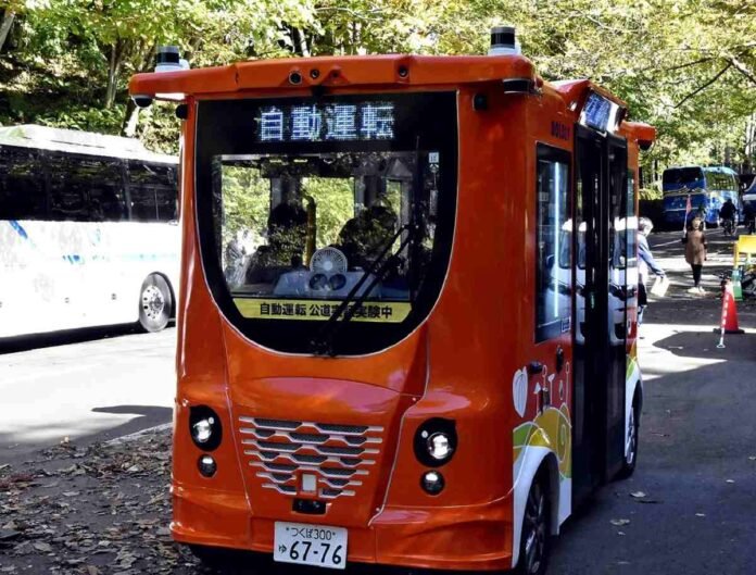 Self-driving car testing conducted in Towada, Aomori Pref; Governor Miyashita drives an automatic steering vehicle near the Oirase Gorge

